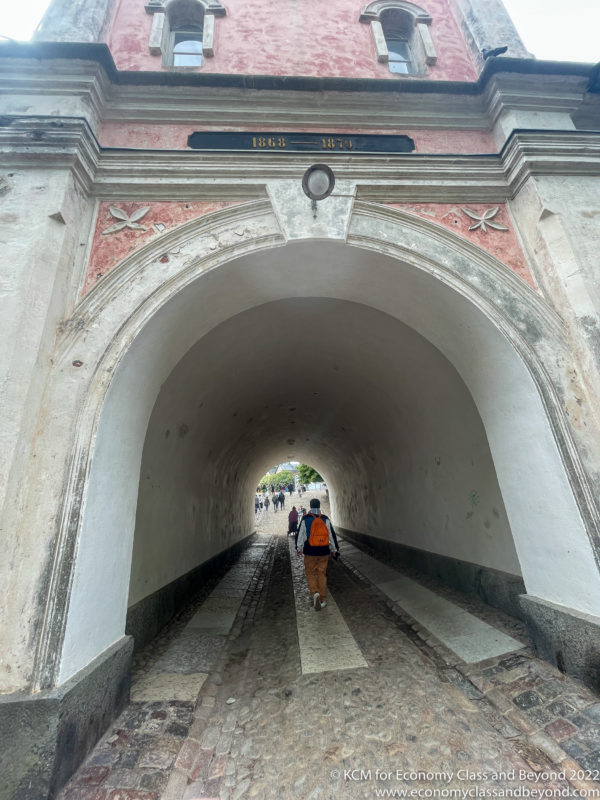 a person walking under a tunnel