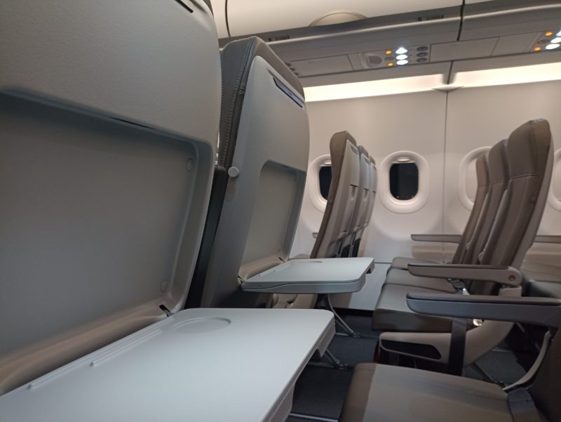 an airplane seats with a table and windows