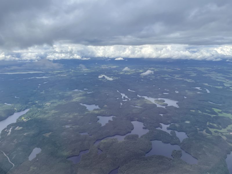 aerial view of a landscape with water and clouds