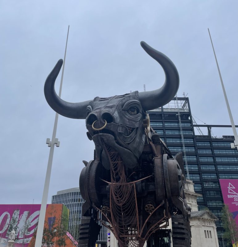 a statue of a bull in a city