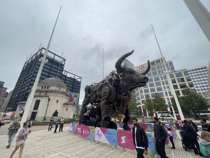 a bull statue in a city