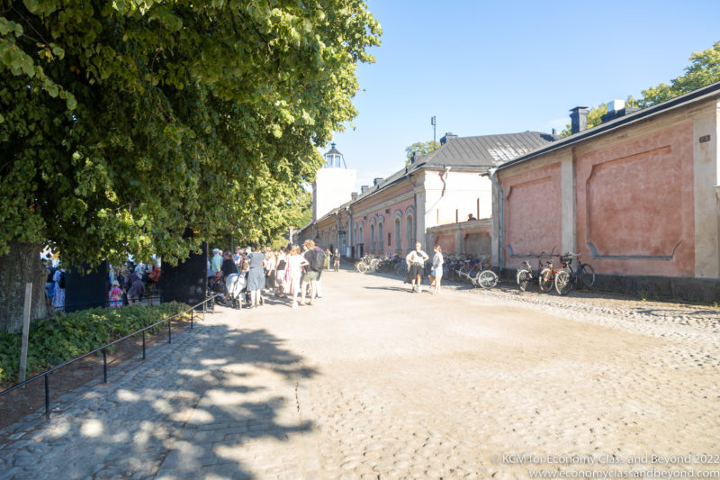 a group of people walking on a cobblestone road