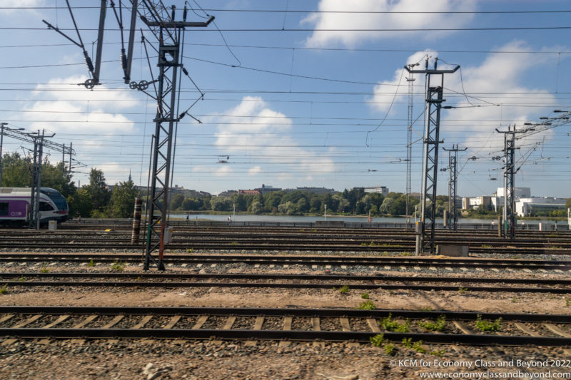 train tracks with power lines and trees in the background