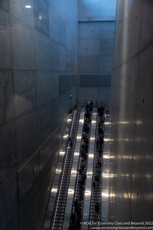 a group of people on escalators in a tunnel
