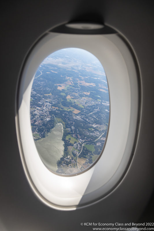 an airplane window with a view of land and a river