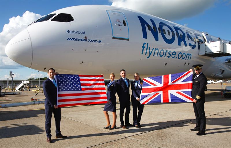 a group of people holding flags in front of a plane