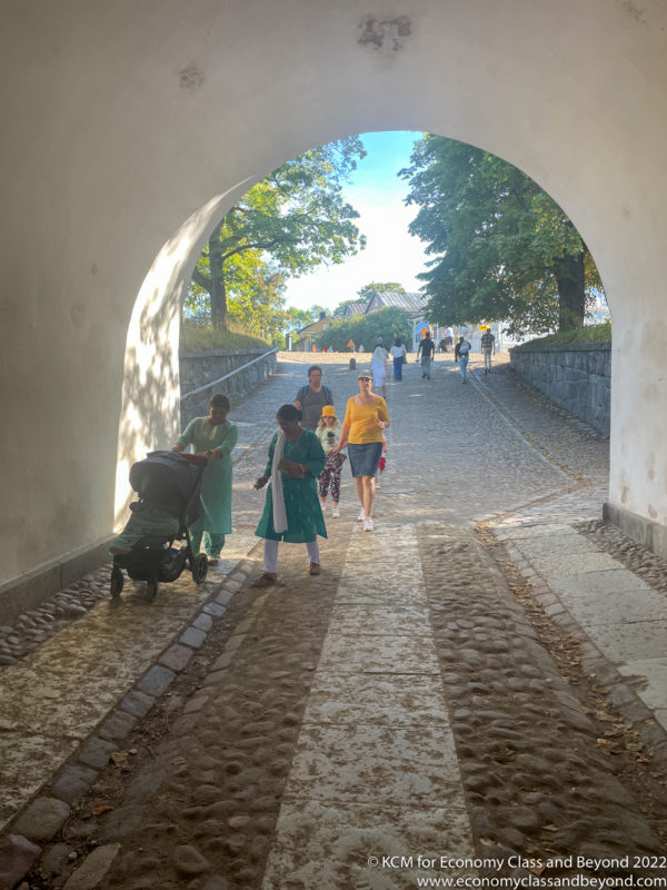a group of people walking under a tunnel