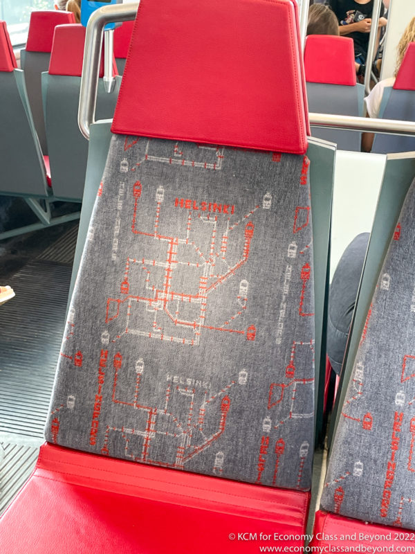 a seat with a red and grey fabric