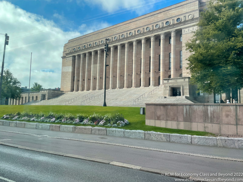 Parliament House, Helsinki with columns and a lawn