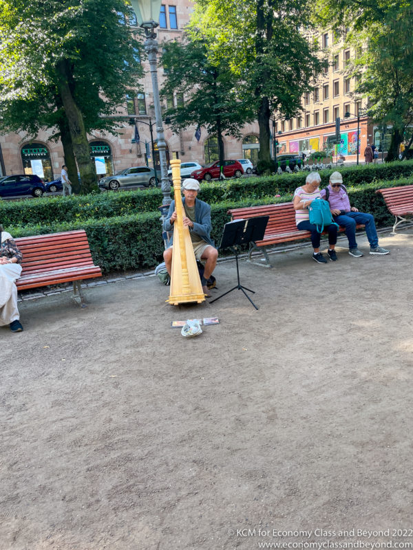 a group of people sitting on benches and playing a musical instrument