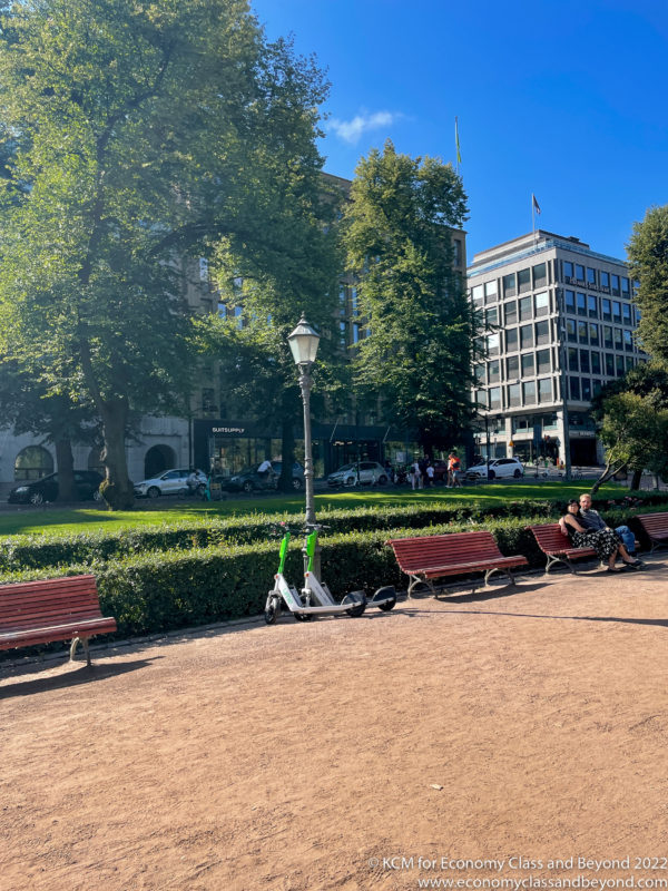 people sitting on benches in a park