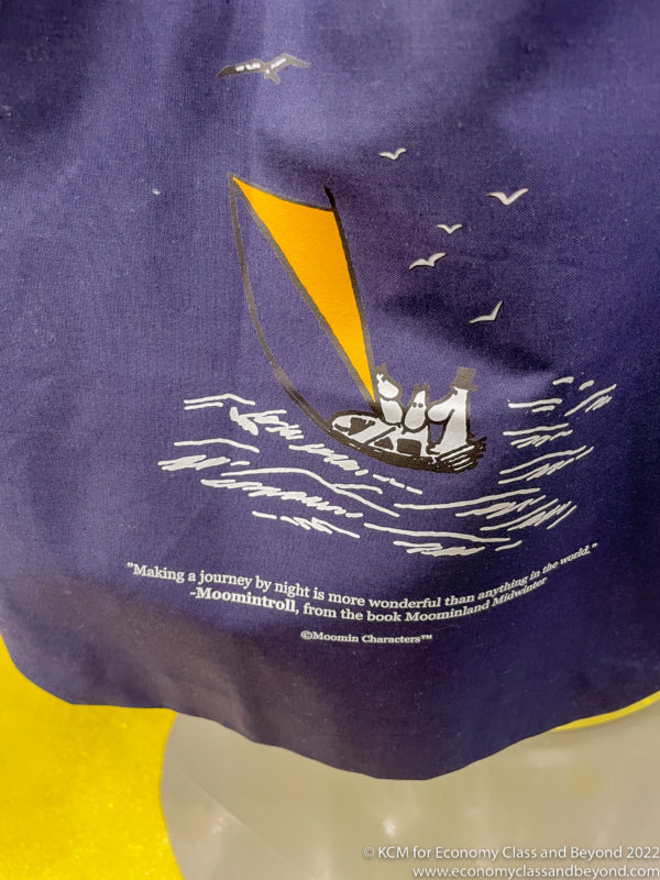 a blue and yellow bag with a picture of a boat and birds