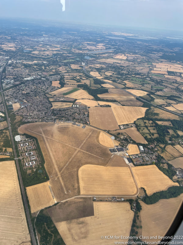 an aerial view of a large area with fields and buildings