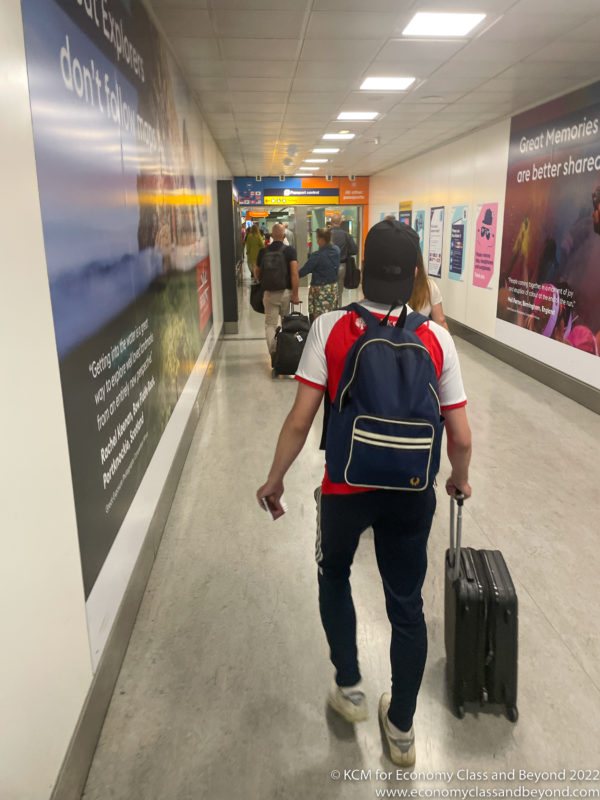 a man with a backpack and luggage in a hallway