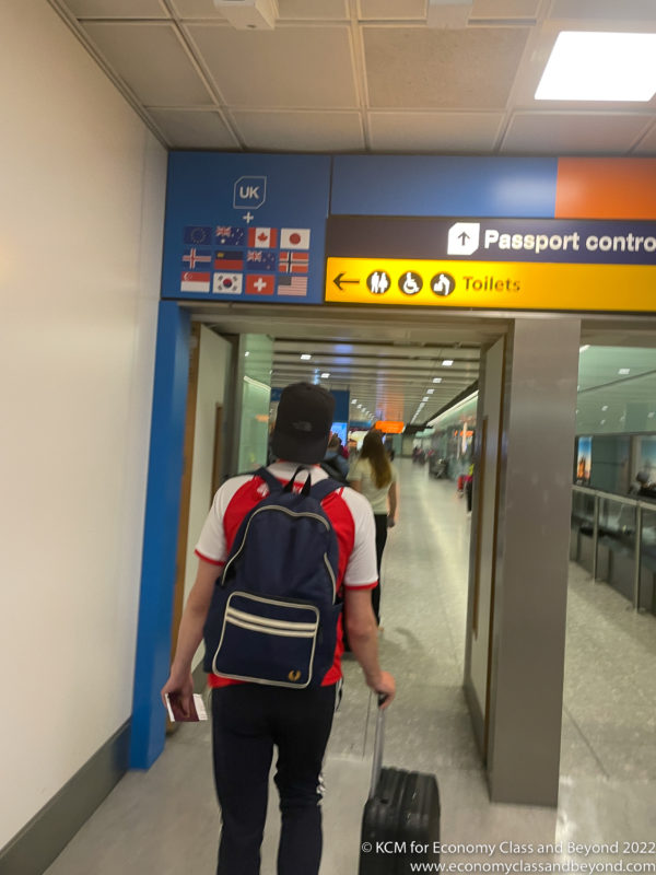 a man with a backpack walking through an airport