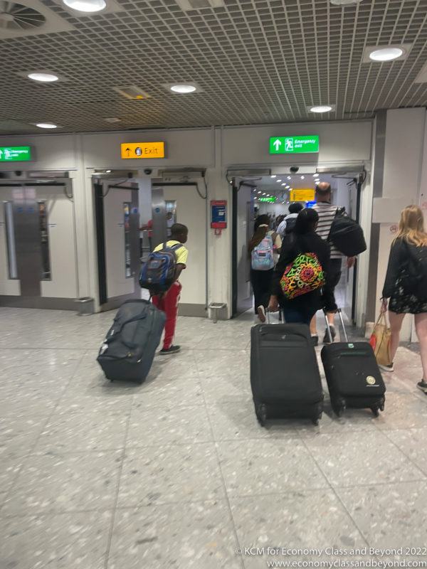 a group of people with luggage in an airport