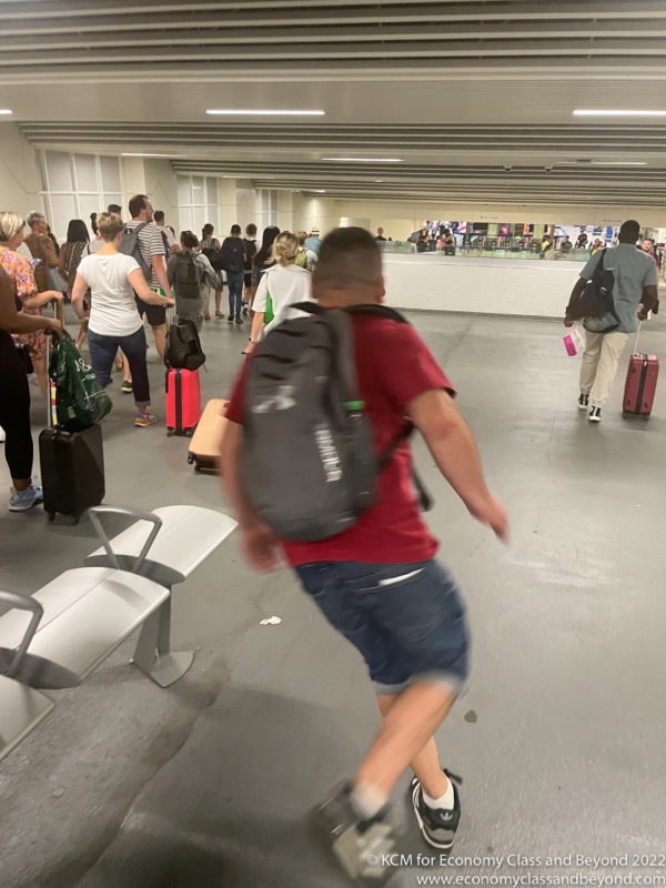 a man running in a large room with many luggage
