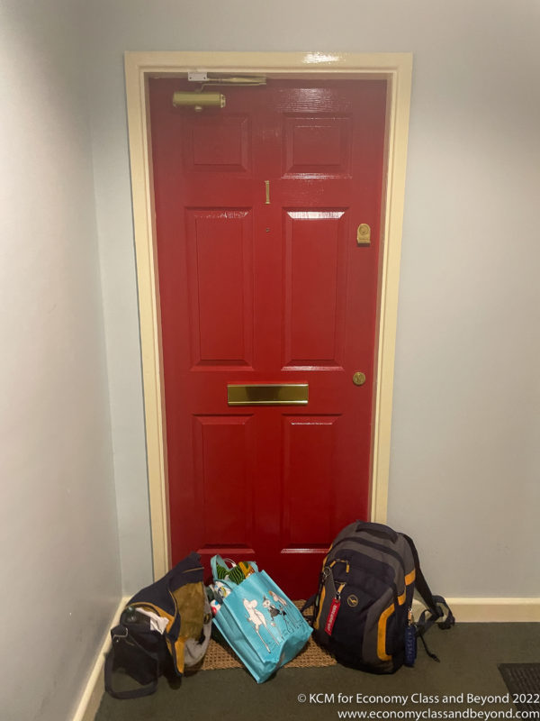 a red door with a bag and a handle