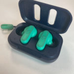 a green earbuds in a black case