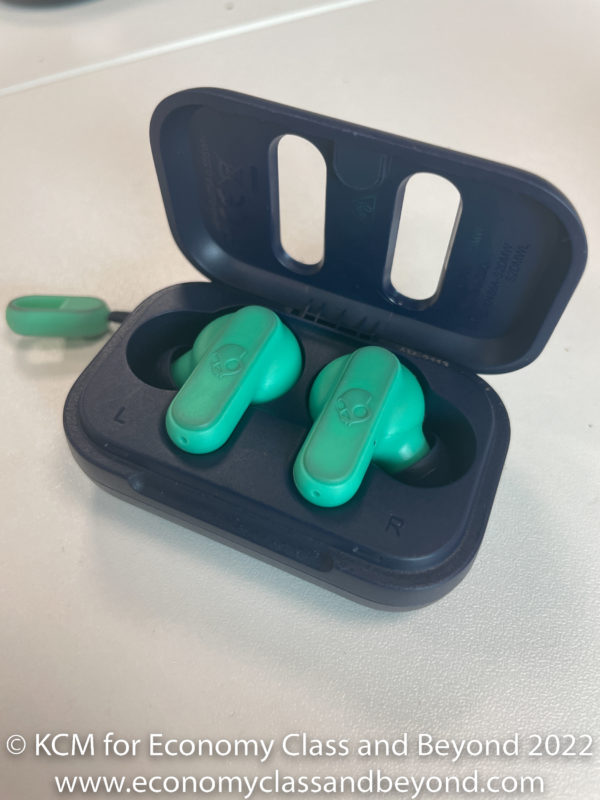 a green earbuds in a black case