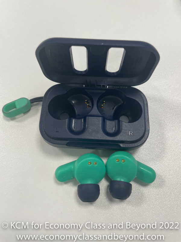 a black box with a green earbuds in it