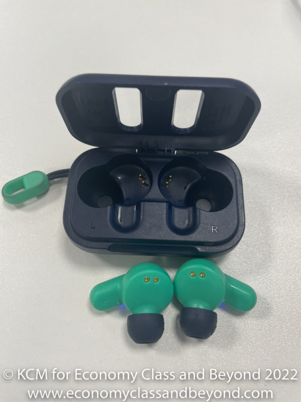 a black box with a green earbuds