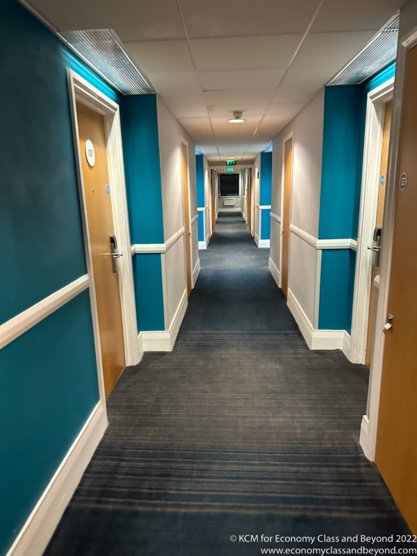 a hallway with blue walls and doors
