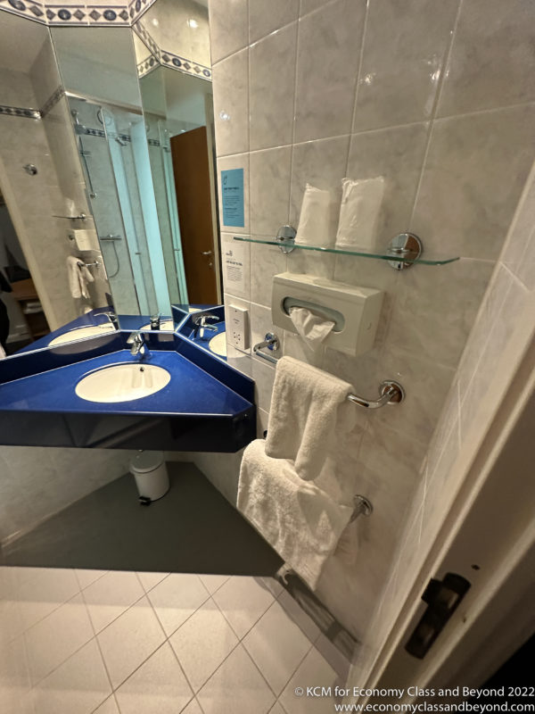 a bathroom with a blue sink and a mirror