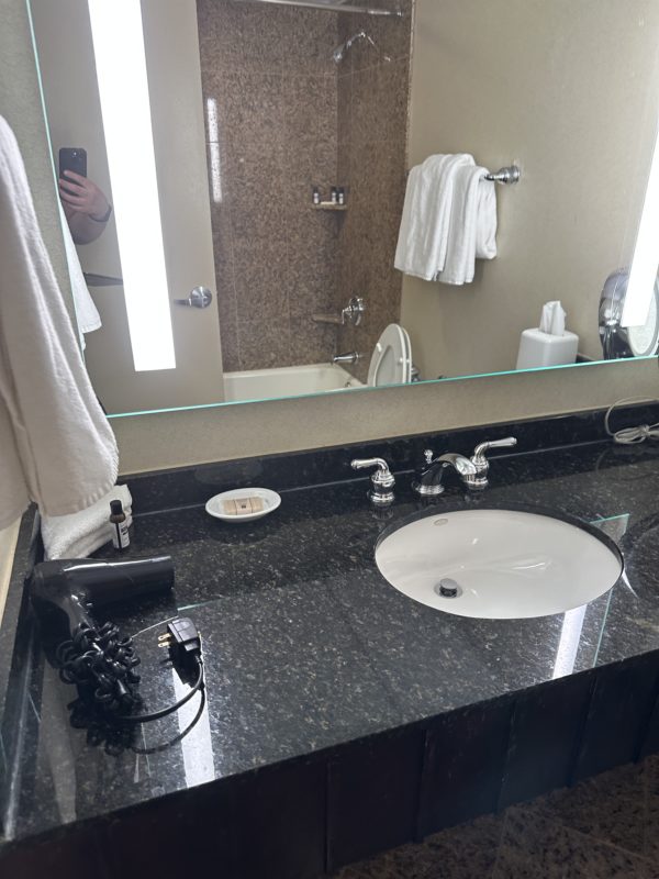 a mirror with a sink and a mirror