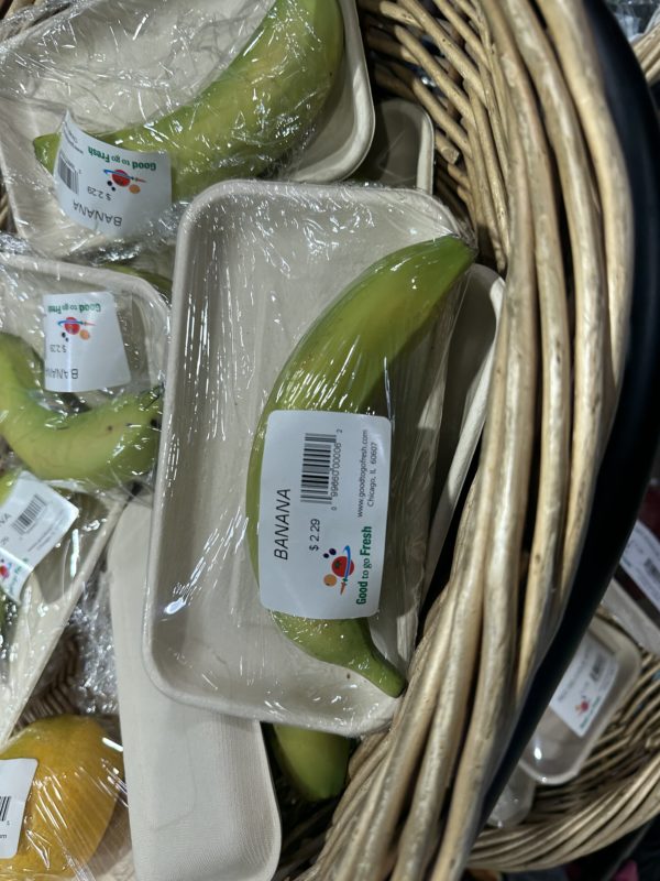 a basket of bananas wrapped in plastic