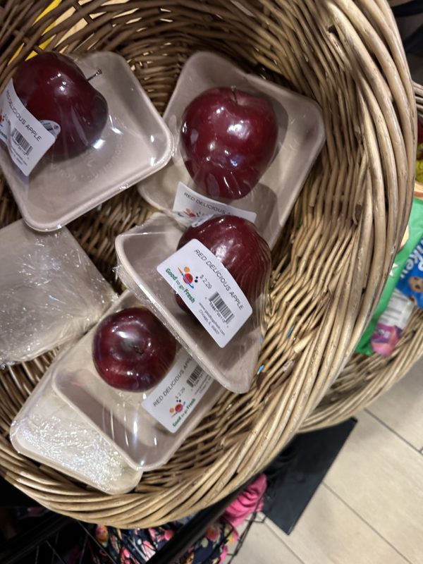 a basket of plastic apples