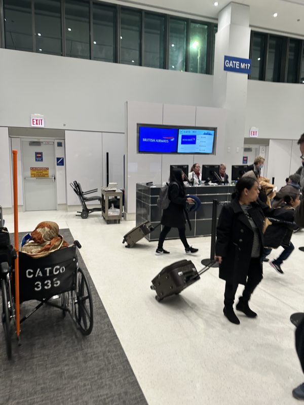 people walking in an airport with luggage