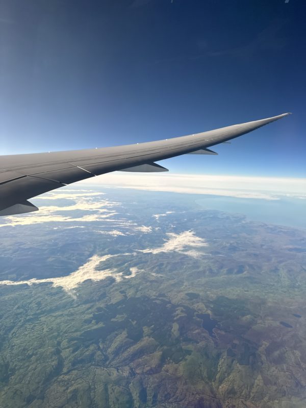 an airplane wing above land