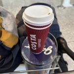 a red coffee cup on a blue lid