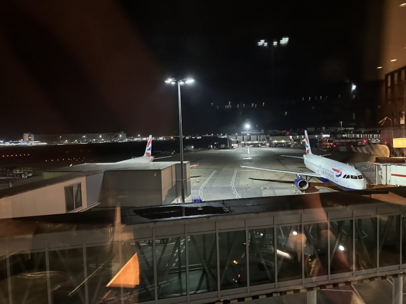 an airport at night with airplanes on the runway