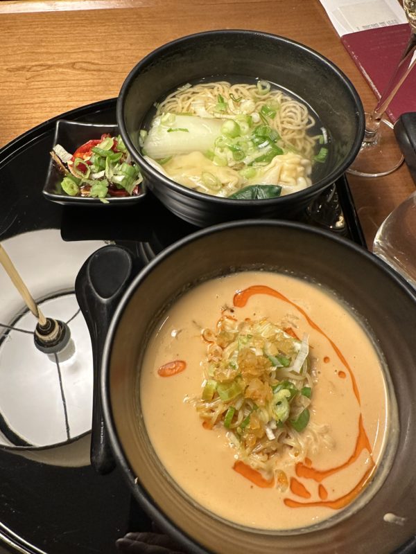 bowls of soup and noodles on a table