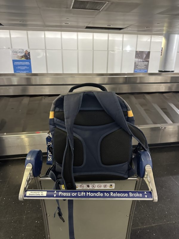 a backpack on a luggage cart