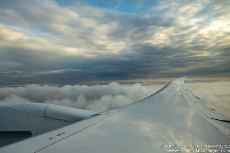 wing of an airplane above clouds