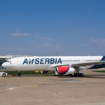 a large white airplane on a runway