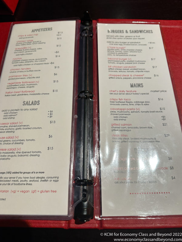 a menu with a black spoon in it