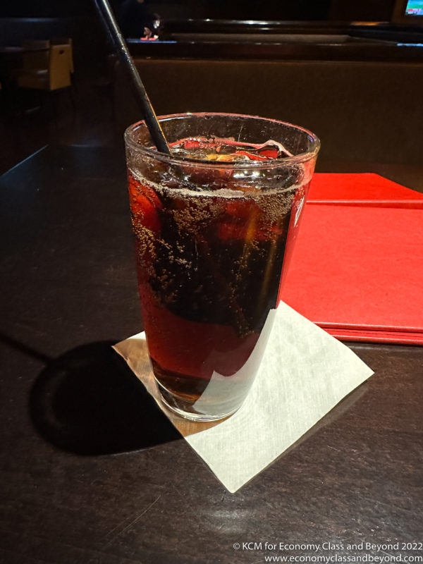 a glass of liquid with a straw