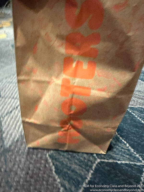 a brown paper bag with orange writing on it