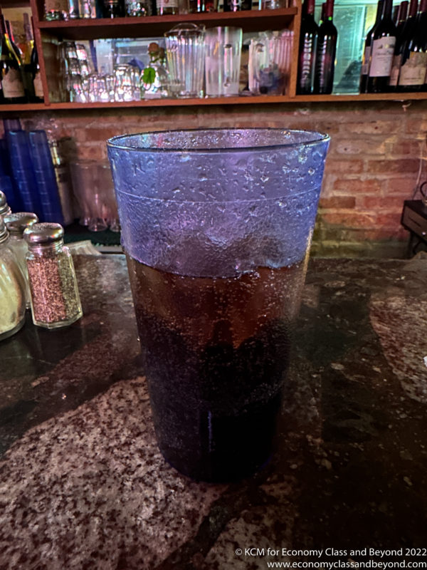 a glass of soda on a counter