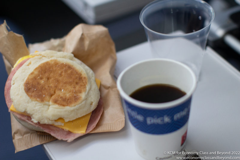 a breakfast sandwich and a cup of coffee