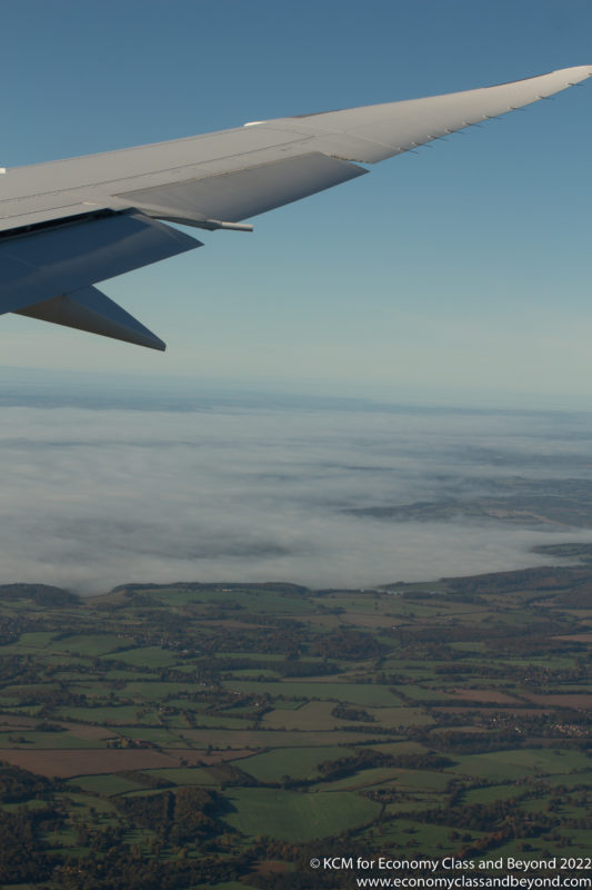 an airplane wing above clouds