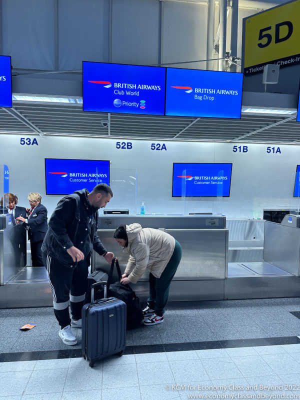a group of people standing next to luggage