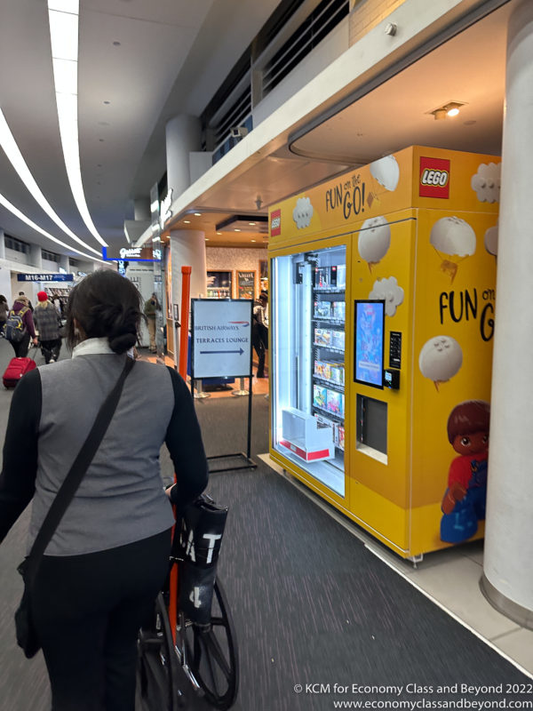 a woman pushing a cart in a yellow vending machine