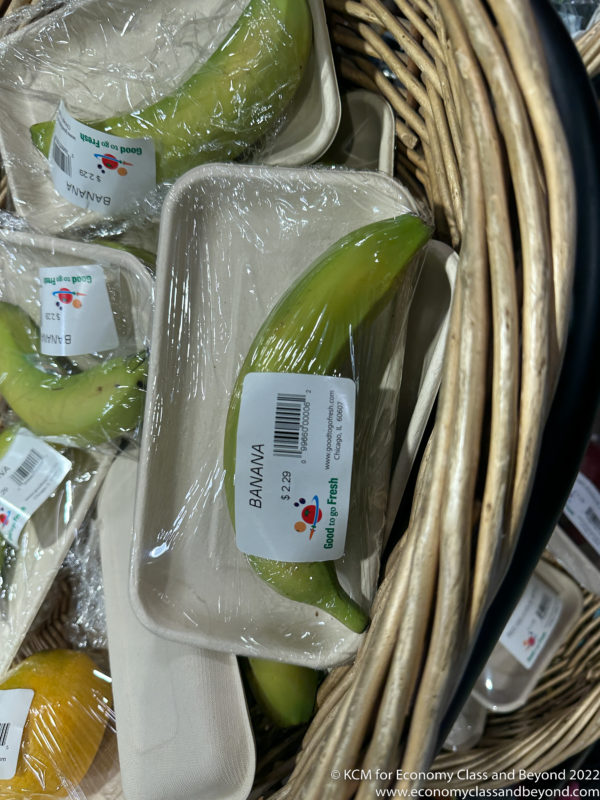 a banana wrapped in plastic in a basket