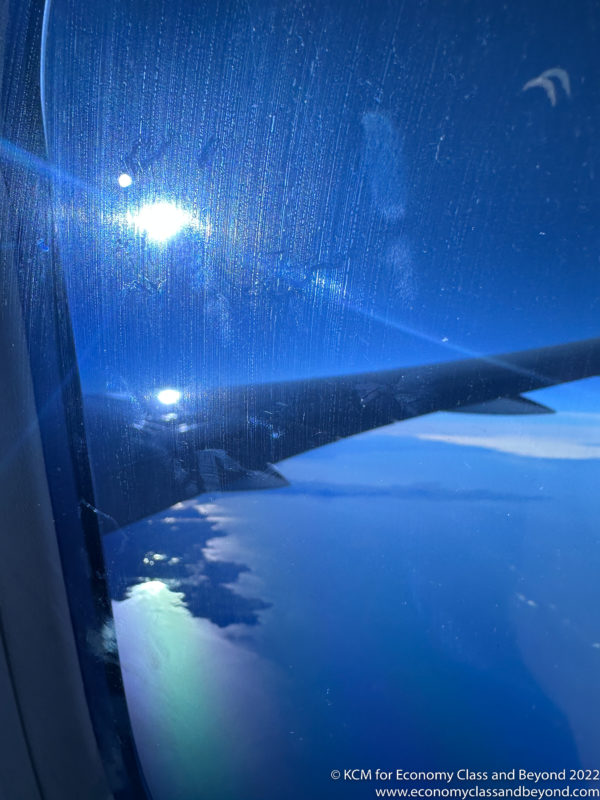 a wing of an airplane seen through a window