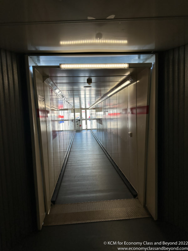a hallway with a walkway and lights